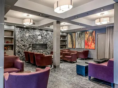 a waiting room at a hospital with purple chairs at Cozy King Condo Mountain Views, Resort Perk and BBQ in Canmore