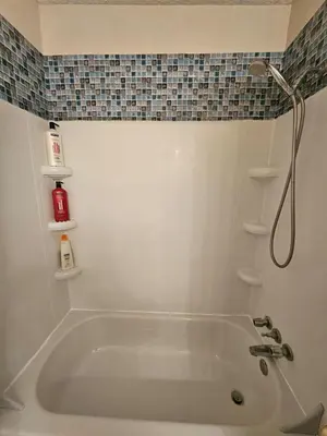 a white bath tub in a bathroom with a shower at The Onyx Suite In Inglewood Minutes To DT in Calgary
