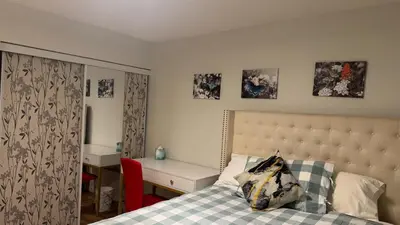 a bedroom with a bed and a desk and a desk at Main Floor Condo Fully Independent 1 Bed 1 Bath in Edmonton