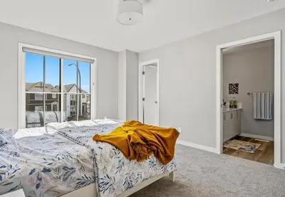 a bedroom with a bed and a large window at Cozy 3-Bedroom Family Retreat Home in Rangeview in Calgary