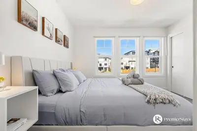 a bedroom with a large bed with a window at Luxurious Designer Finished Home in Calgary