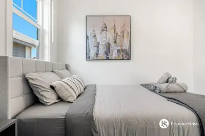 a living room with a couch and a picture on the wall at Luxurious Designer Finished Home in Calgary