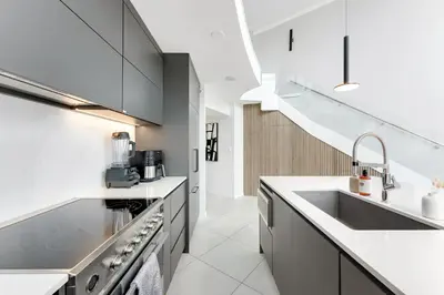 a kitchen with white countertops and a sink at The Vancouver Penthouse, 2-Level, Patios, Hot Tub in Vancouver