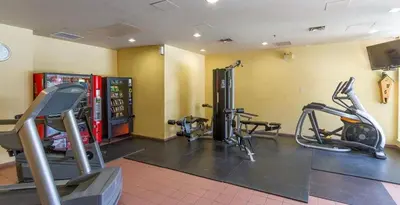a gym with two treadmills and cardio machines at Cascade Lodge Studio-steps from village in Whistler