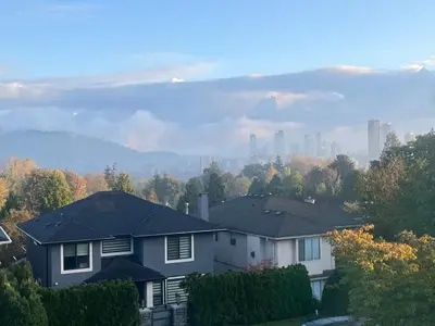 a group of houses with a city in the background at Lovely suite in Burnaby