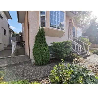 a house with a bush in front of it at Lovely suite in Burnaby