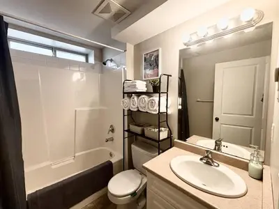 a bathroom with a sink and a toilet and a tub at Bella Sweet Suite -Cozy 2B suite Morgan Creek in Surrey