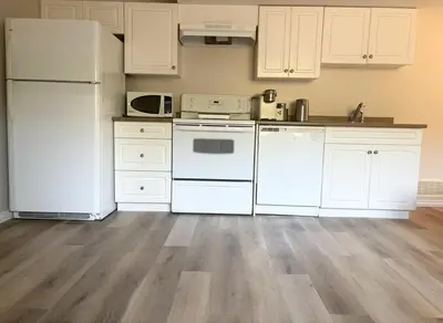 a kitchen with white appliances and white cabinets at Bella Sweet Suite -Cozy 2B suite Morgan Creek in Surrey