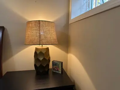 a lamp sitting on top of a table with a picture at UBC Two-Bedroom Suite - Steps from Beach, Park & Golf - Full Kitchen in Vancouver