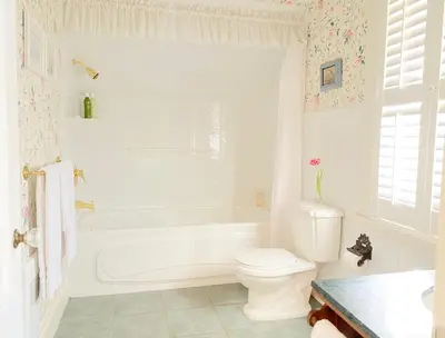 a bathroom with a tub and a toilet and a sink at Princess and the Pea Hotel in Langley