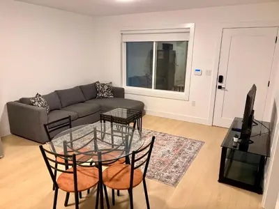 a living room with a couch and a glass table at Cozy Private Suite in Langley in Langley