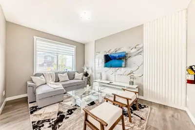 a living room with a couch and a table at Cozyhub Vacation Rental Calgary-3Bedroom with AC in Calgary