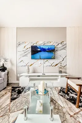 a living room with a tv on a wall at Cozyhub Vacation Rental Calgary-3Bedroom with AC in Calgary