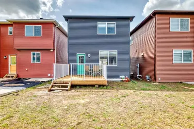two houses in a yard with a playground in front at Cozyhub Vacation Rental Calgary-3Bedroom with AC in Calgary