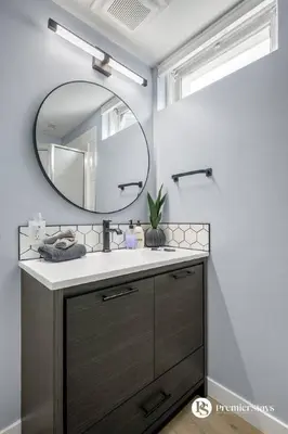 a bathroom with a sink and a mirror at Spacious Cozy Couples Getaway Basement Suite in Sundance in Calgary