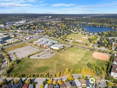 an aerial view of a campus with a park at Spacious Cozy Couples Getaway Basement Suite in Sundance in Calgary