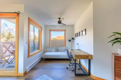 a living room with a couch and a table at Bluebird - Spacious Luxury Shared Rooftop Hot Tub in Canmore