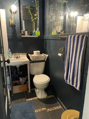 a bathroom with a toilet and a sink at Ophelias Casa in Vancouver