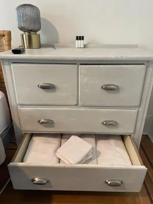 a dresser with a drawer filled with towels at Ophelias Casa in Vancouver