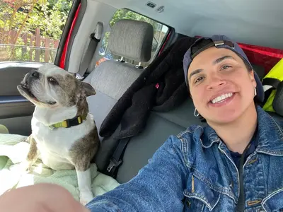 a man sitting in the back seat of a car with a dog at Ophelias Casa in Vancouver