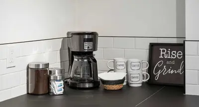 a coffee maker sitting on top of a counter at The Sunny 2 Suites 10 Pax Pet Friendly Stay in Calgary