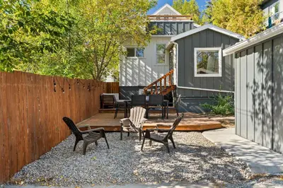 a backyard with chairs and a wooden fence at The Lokal 2 Kings Queen Suite in Sunnyside YYC in Calgary