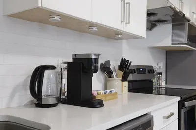 a coffee maker sitting on a counter in a kitchen at Cozy 2BR for Family & Private Parking & Near Mall in Langley