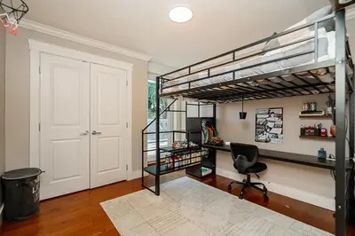 a room with a loft bed with a desk and a chair at World Cup Coastal Getaway in White Rock