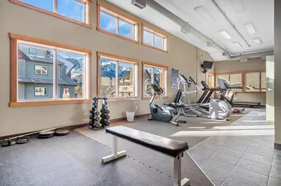 a gym with several treadmills and exercise bikes at Lodges at Canmore Resort in Canmore