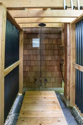 a wooden structure with a shower in a building at South Swell Tofino (formerly Blue Heron Waterfront Home amid Old Growth Cedars) in Tofino