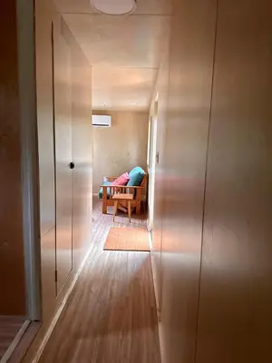 a hallway with a room with a couch and a table at Riverside Retreat in Cowichan Bay