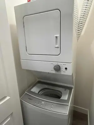 a washer and dryer in a small bathroom at Bright & Modern 1-Bedroom Guest Suite in Chilliwack