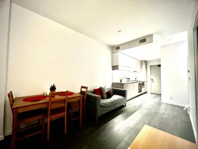 a living room with a dining room table and a kitchen at Cozy and convenient 1B1B near Richmond center in Richmond