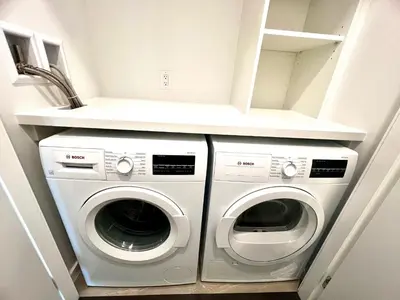 a laundry room with two washer and dryer at Cozy and convenient 1B1B near Richmond center in Richmond