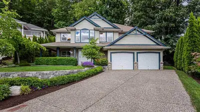 a house with a driveway in front of it at Beautiful Mountain Retreat with a View in Abbotsford