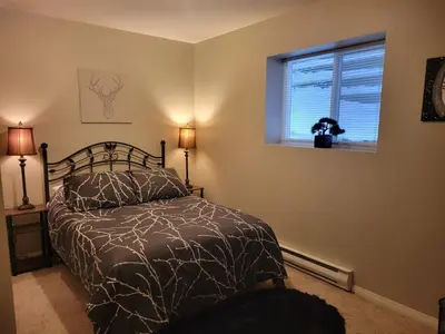 a bedroom with a bed and a window at Beautiful Mountain Retreat with a View in Abbotsford