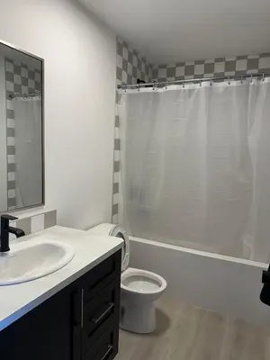 a bathroom with a toilet and a sink and a shower at Modern new townhouse in Red Deer