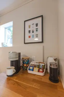 a kitchen counter with a coffee maker and a coffeemaker at Modern Lynn Valley Retreat with Mountain and City Views in North Vancouver