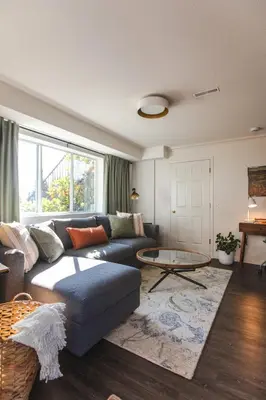 a living room with a couch and a table at Modern Lynn Valley Retreat with Mountain and City Views in North Vancouver