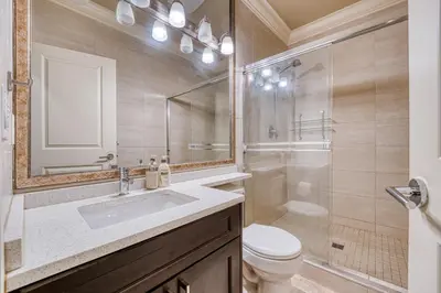 a bathroom with a sink and a toilet and a shower at Cozy two beds lower level suite in Vancouver West in Vancouver