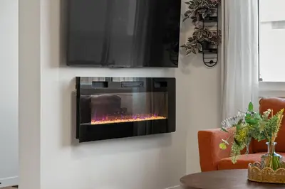 a fireplace in a living room with a tv at Brand New Cozy2BR House NW Calgary DT Banff Sleep4 in Calgary