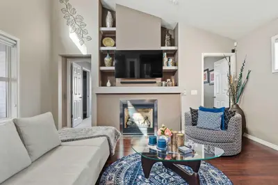 a living room with a couch and a fireplace at Large Family Home w Kid's Play Tent! FREE Banff Pass in Calgary
