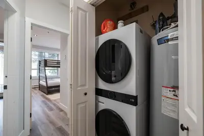 a microwave and a washer and dryer in a room at Symphony 8 by Outpost Whistler in Whistler