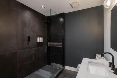 a bathroom with a shower with a glass door at Symphony 8 by Outpost Whistler in Whistler