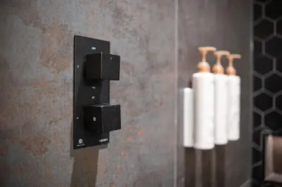 a bathroom with a towel dispenser on a wall at Symphony 8 by Outpost Whistler in Whistler