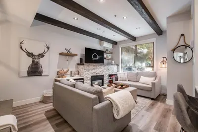 a living room with a couch and a fireplace at Symphony 8 by Outpost Whistler in Whistler