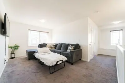 a living room with a couch and a table at Spacious Suite in Calgary