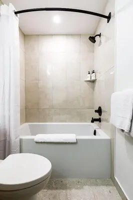 a bathroom with a white tub and a toilet at Aurora Lite - Brand new suite with private entrance in Canmore