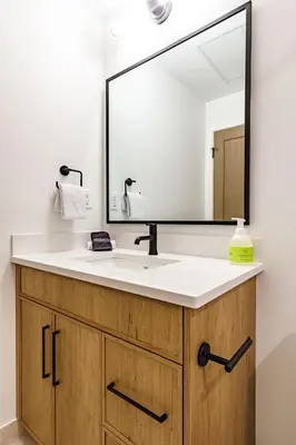 a bathroom with a sink and a large mirror at Aurora Lite - Brand new suite with private entrance in Canmore