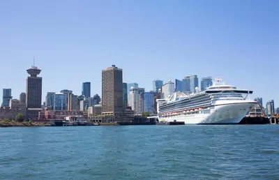 a cruise ship docked in a harbor with a city at Historic Downtown Escape in Vancouver